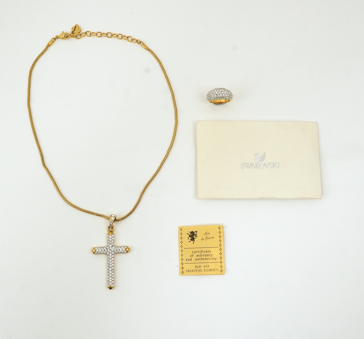 A Swarovski vintage cross necklace and ring.